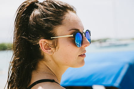 shallow focus photography of woman wearing blue sunglasses thumbnail