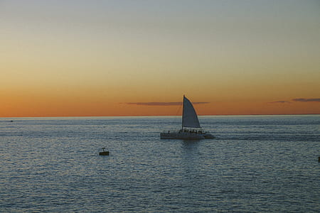 sailboat on body of water during golden hour thumbnail