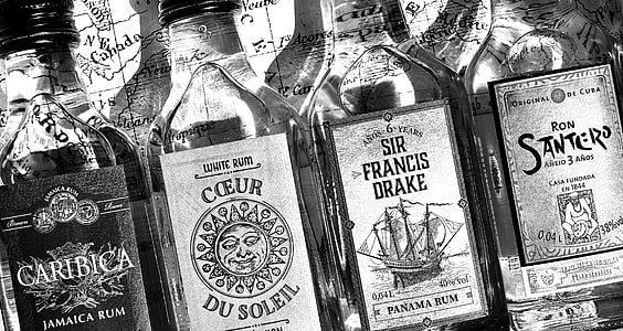 grayscale photo of liquor bottles thumbnail