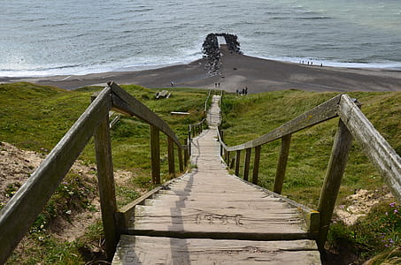 brown wooden stairs towards seashore thumbnail