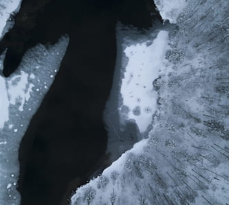aerial view of water beside snowfield thumbnail
