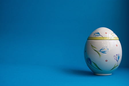 selective focus photography of white, blue, and green floral egg table decor thumbnail