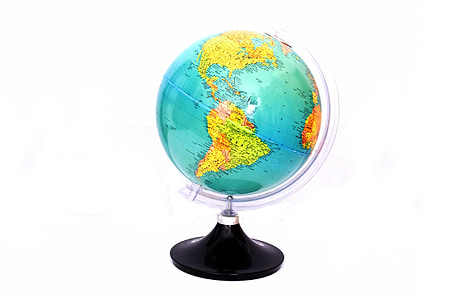 green and black desk globe on white surface thumbnail
