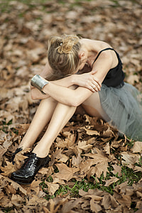 woman wearing black spaghetti-strap dress sitting in the ground thumbnail