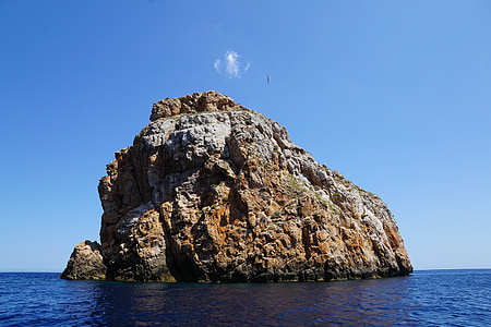 brown rock formation in body of water thumbnail