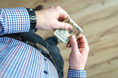 Person Holding 100 Us Dollar Banknote thumbnail