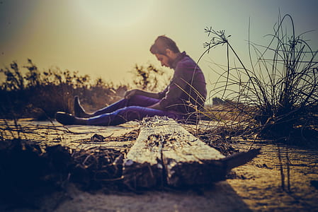 Man Sitting Near Brown Wood Plank thumbnail