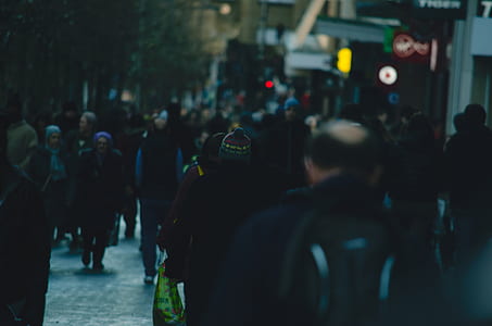 people walking on pathway near buildings thumbnail