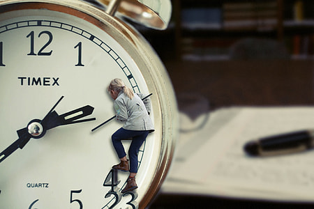 macro photography of gold Timex analog table alarm clock showing 2:40 thumbnail