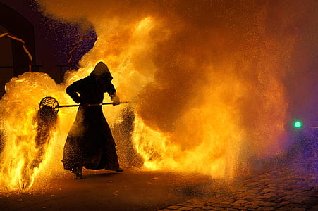 man holding tool near fire thumbnail