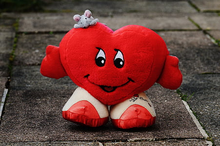 red and white heart character standing on concrete pavement thumbnail