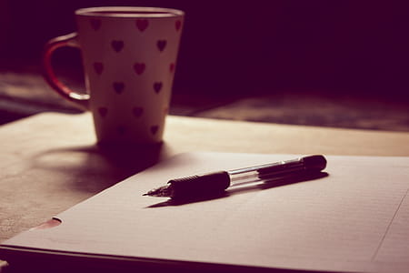Black Pen on White Printed Paper Near White Ceramic Mug thumbnail