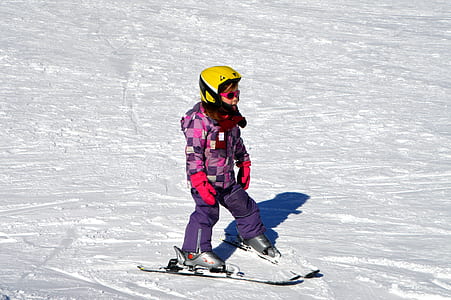 toddler with ski boards on snow thumbnail