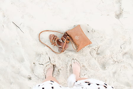 brown leather crossbody bag beside leather slippers thumbnail