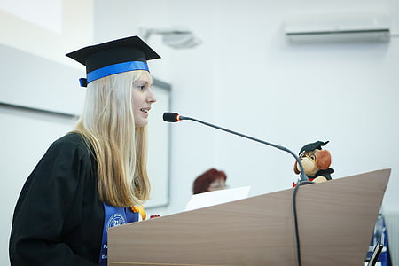 woman standing in front of desk with microphone thumbnail