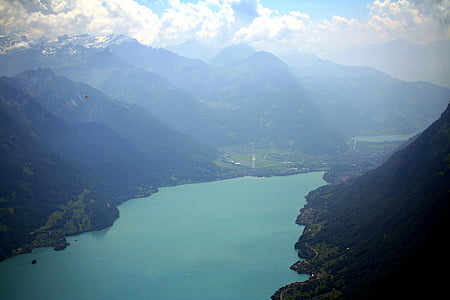 body of water surrounded with mountains at daytime thumbnail