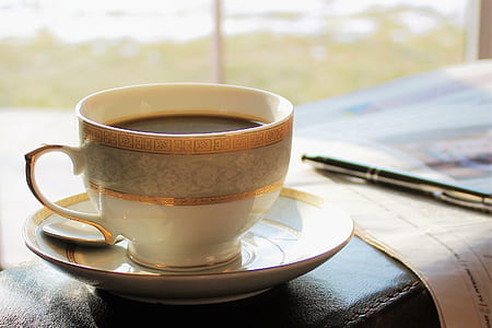 coffee mug filled with black coffee thumbnail