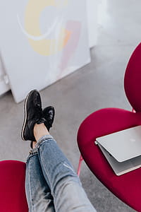 Woman using laptop computer and sitting cross legs on sofa thumbnail