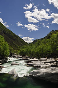 body of water near mountain at daytime thumbnail