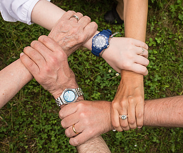 four persons holding each other thumbnail