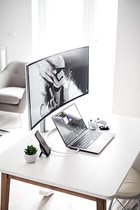 turned on laptop on white table thumbnail