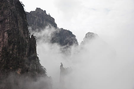 gray mountains covered in fog during daytime thumbnail