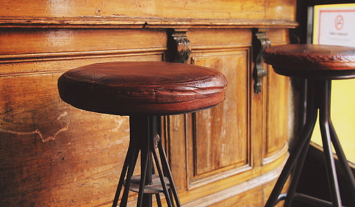 two round brown padded stool chairs thumbnail