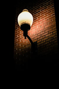 lighted wall lantern on brick wall thumbnail