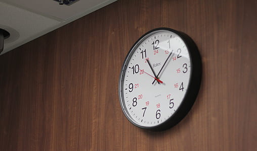 round black and white analog wall clock displaying 11:09 time on wall thumbnail