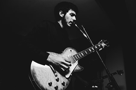 Man singing and playing the guitar thumbnail