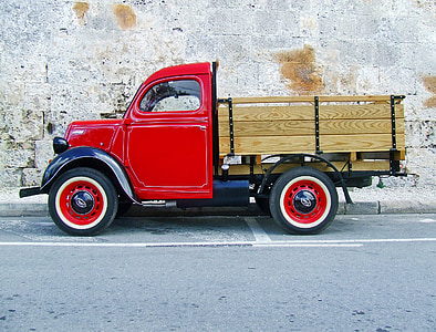 red stake truck on road thumbnail