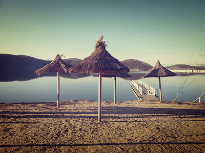open nipa cottages near body of water thumbnail