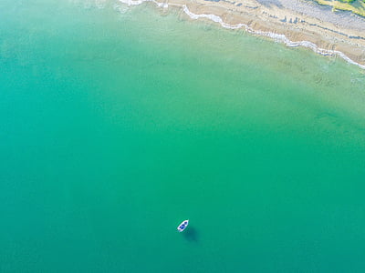 bird's eye view of boat in body of water thumbnail