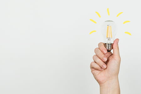 Hand With Idea Lightbulb Photo thumbnail