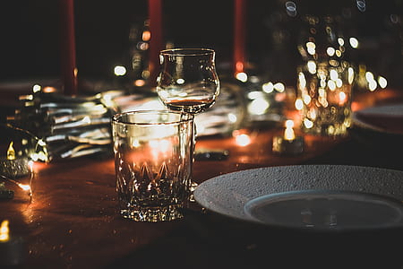 wine glass near plate and drinking glass on table thumbnail