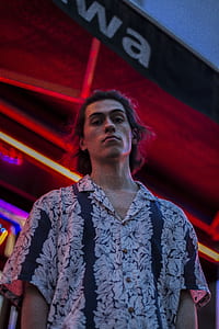 man wearing white and blue floral button-up t-shirt thumbnail