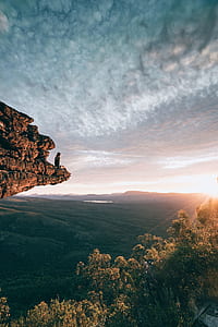 person sitting on rock monolith thumbnail