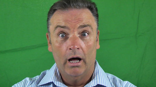 man in white and blue pinstriped collared shirt near green textiles thumbnail