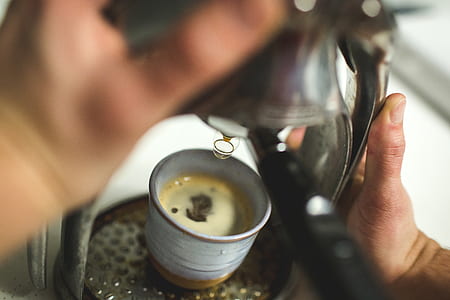 person holding coffeemaker thumbnail