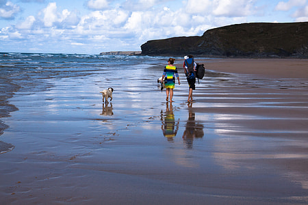 woman wearing yellow, black, and blue dress walking on shore thumbnail