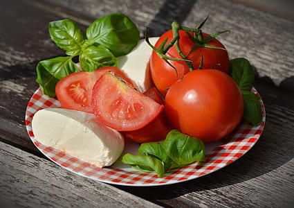 sliced tomatoes, basil, and parmesan cheese served on plate thumbnail