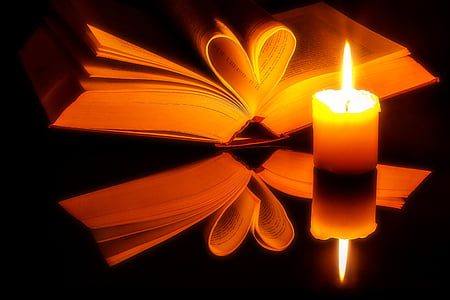 yellow candle beside of book thumbnail
