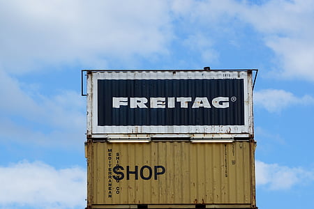 three black and yellow shipping containers at daytime thumbnail