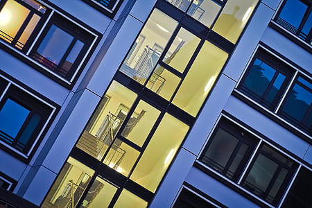 clear glass building showing staircases and rooms in close-up photo thumbnail
