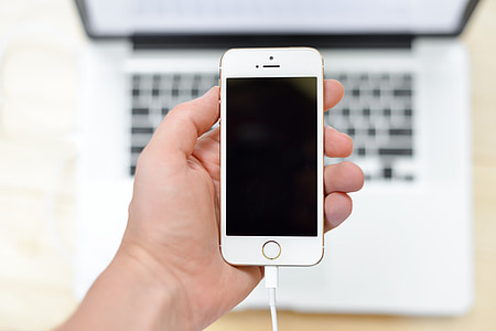 person holding rose gold iPhone SE thumbnail