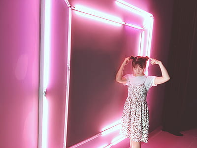 woman standing near lighted fluorescent lights thumbnail