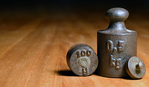 cylindrical black metal tool on brown wooden board thumbnail