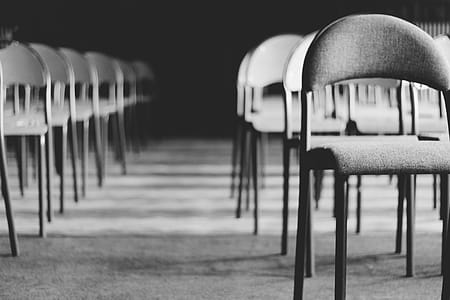 Grayscale Photo of Empty Folding Chairs thumbnail