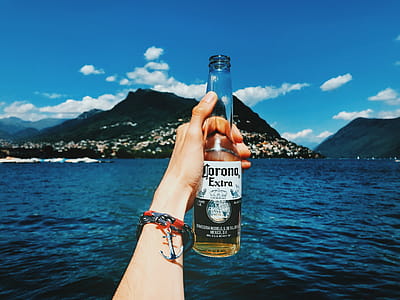Person Holding Corona Extra Beer Bottle thumbnail