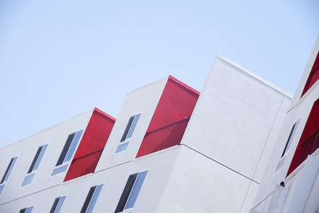 photo of white and ref concrete building under blue sky thumbnail